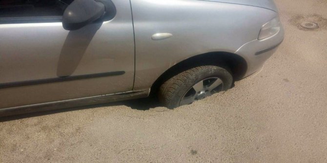 Otomobil tekeri çöken asfalta saplandı